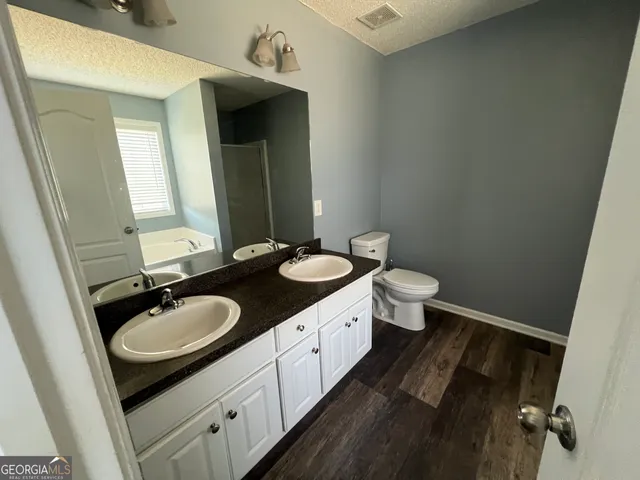 a bathroom with a double vanity sink and a mirror