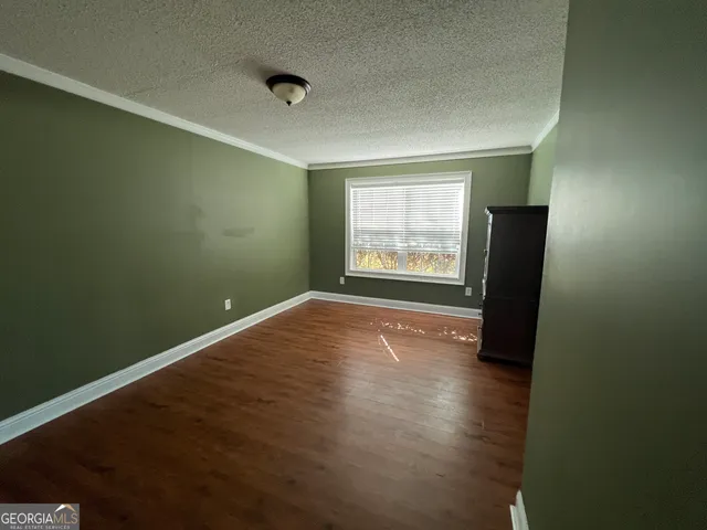 a view of livingroom and hallway with wooden floor