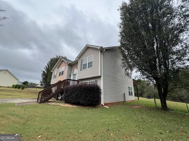 a car parked in front of white house