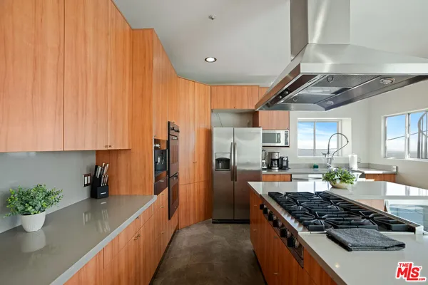 a living room with furniture a clock and a large window