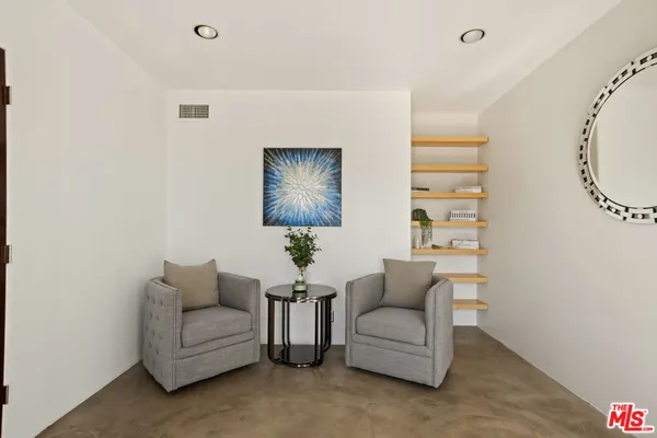 a bedroom with a bed and a television