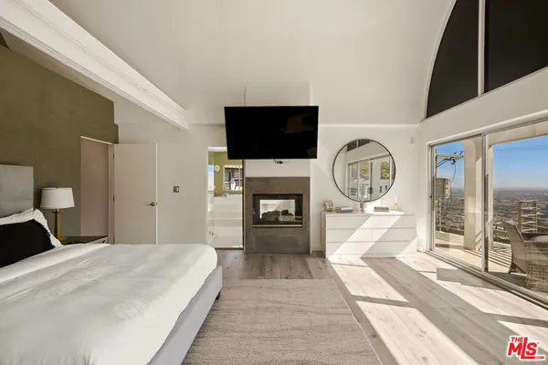 a bedroom with a large bed and a window