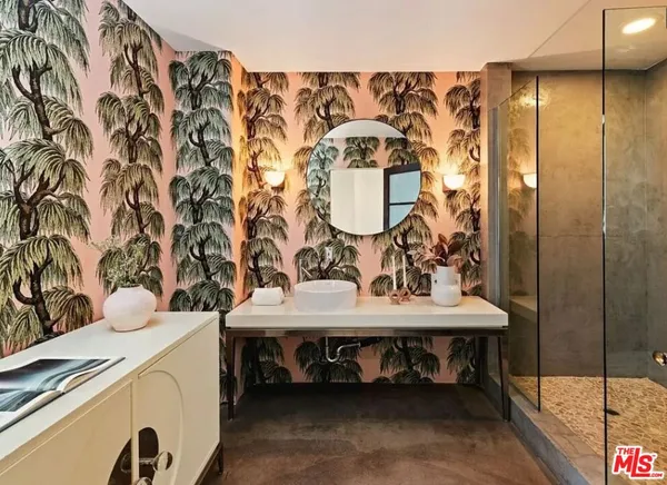 a bathroom with a tub sink and mirror