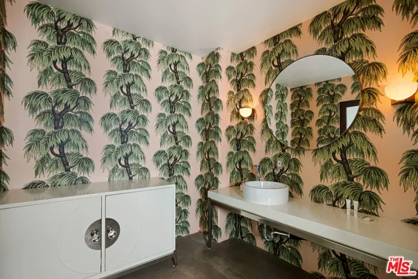 a spacious bathroom with a double vanity sink and a mirror