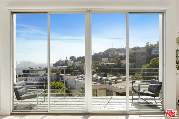 a bedroom with a large bed and a flat screen tv