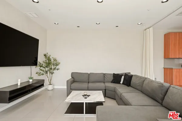 a living room with fireplace furniture and a flat screen tv