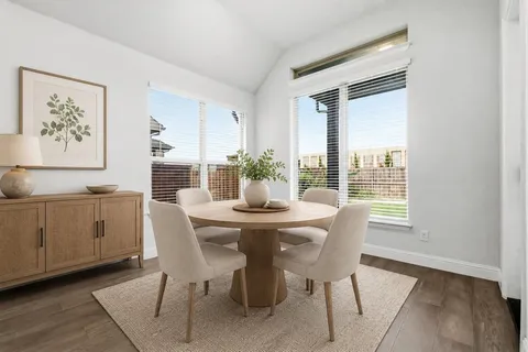 a view of a dining room with furniture and window