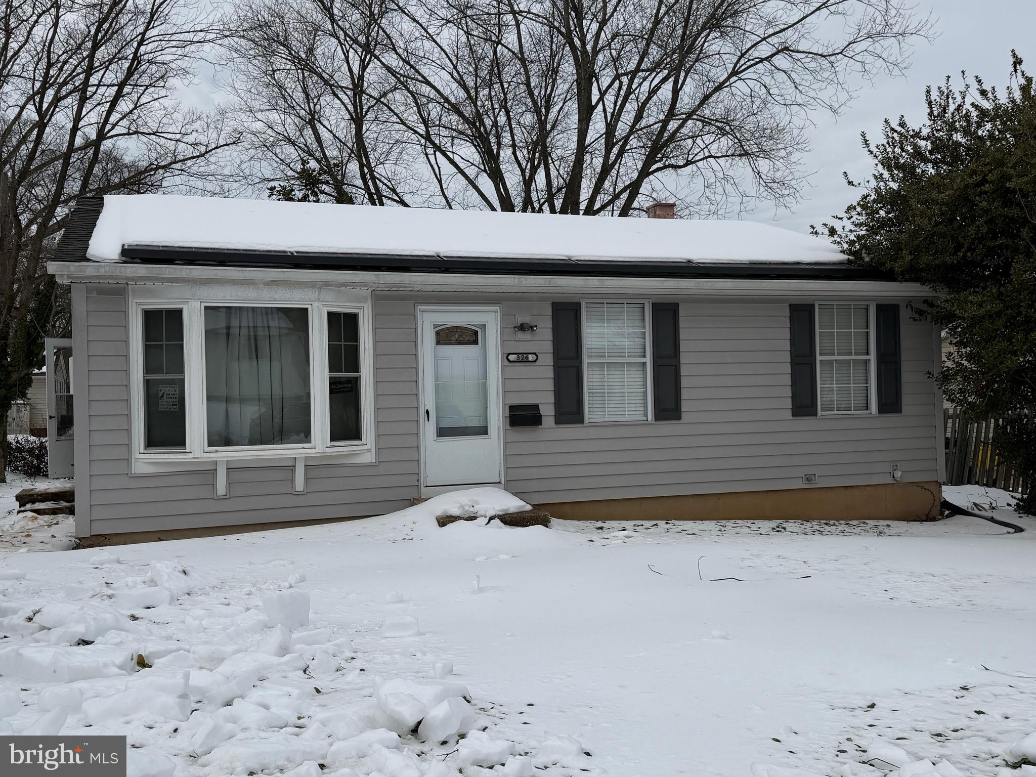 a view of a house with a snow in the yard