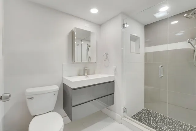 a bathroom with a toilet sink and shower