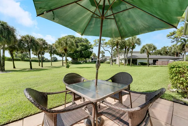 a view of a table and chairs in the garden