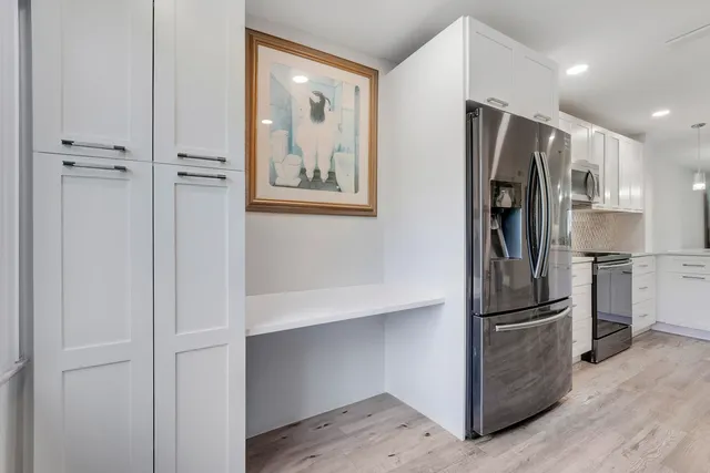 a kitchen with stainless steel appliances a refrigerator and cabinets