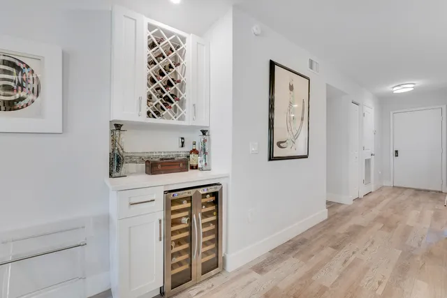 a hallway with cabinet and painting on the wall