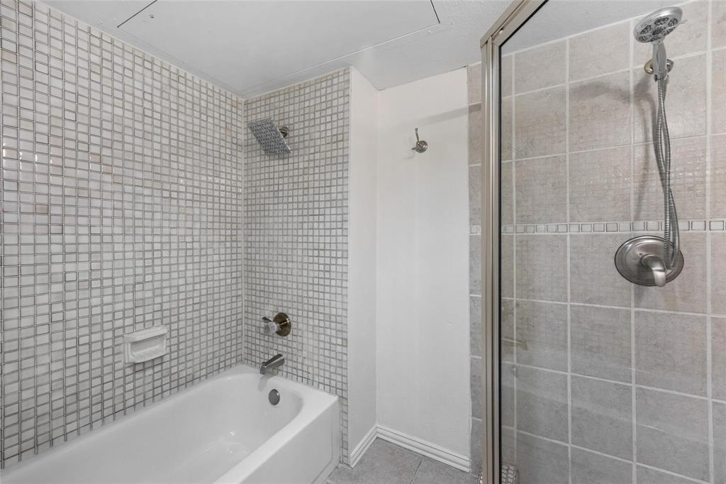 18240 Midway Road, Unit 402 Dallas, TX 75287 - Photo 18 of 29 Bathroom with a full-size tub, mosaic tile surround, rainfall showerhead, and brushed nickel fixtures