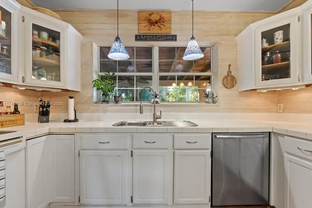 a kitchen with cabinets and window
