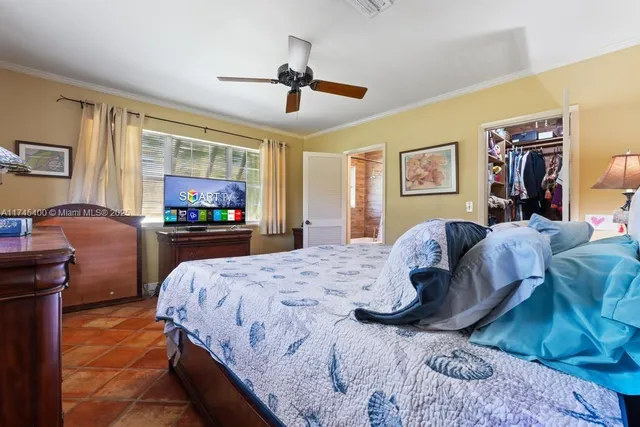 a bedroom with bed and wooden floor
