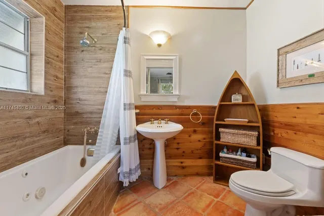 a bathroom with a toilet a sink and bathtub