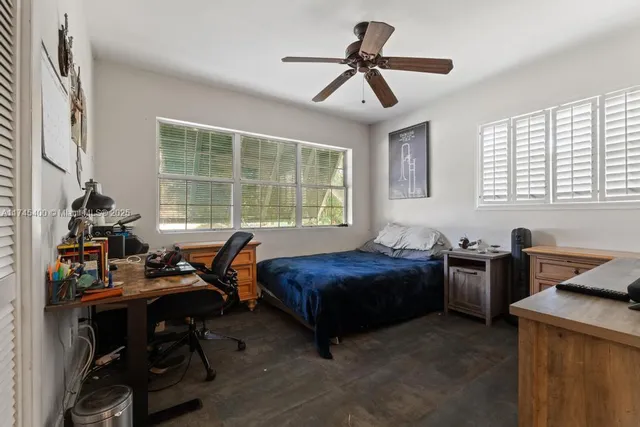 a bed room with furniture and windows