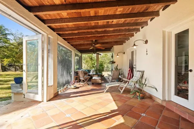 a building outdoor space with patio furniture and garden