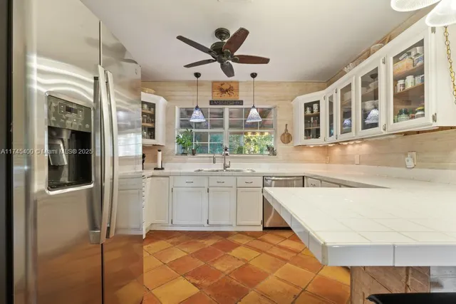a kitchen with a refrigerator and a sink
