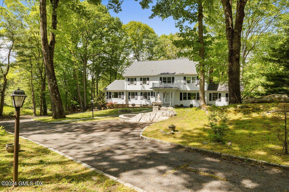 a view of a house with pool and sitting area