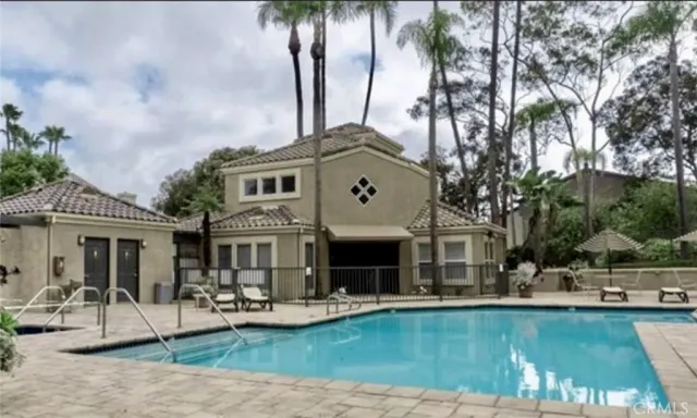a front view of house with yard and swimming pool