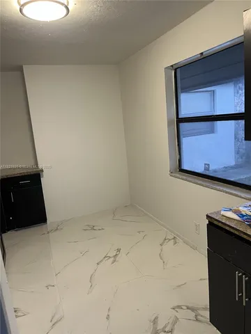 a kitchen with a refrigerator and a stove