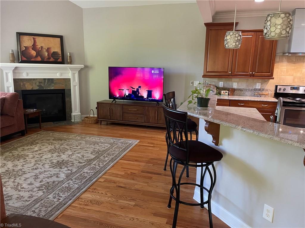 9012 Ray Road Raleigh, NC 27613 - Photo 28 of 42 Den view of fireplace, tv, bar and kitchen new