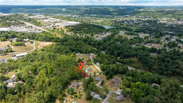 an aerial view of residential houses with outdoor space and swimming pool