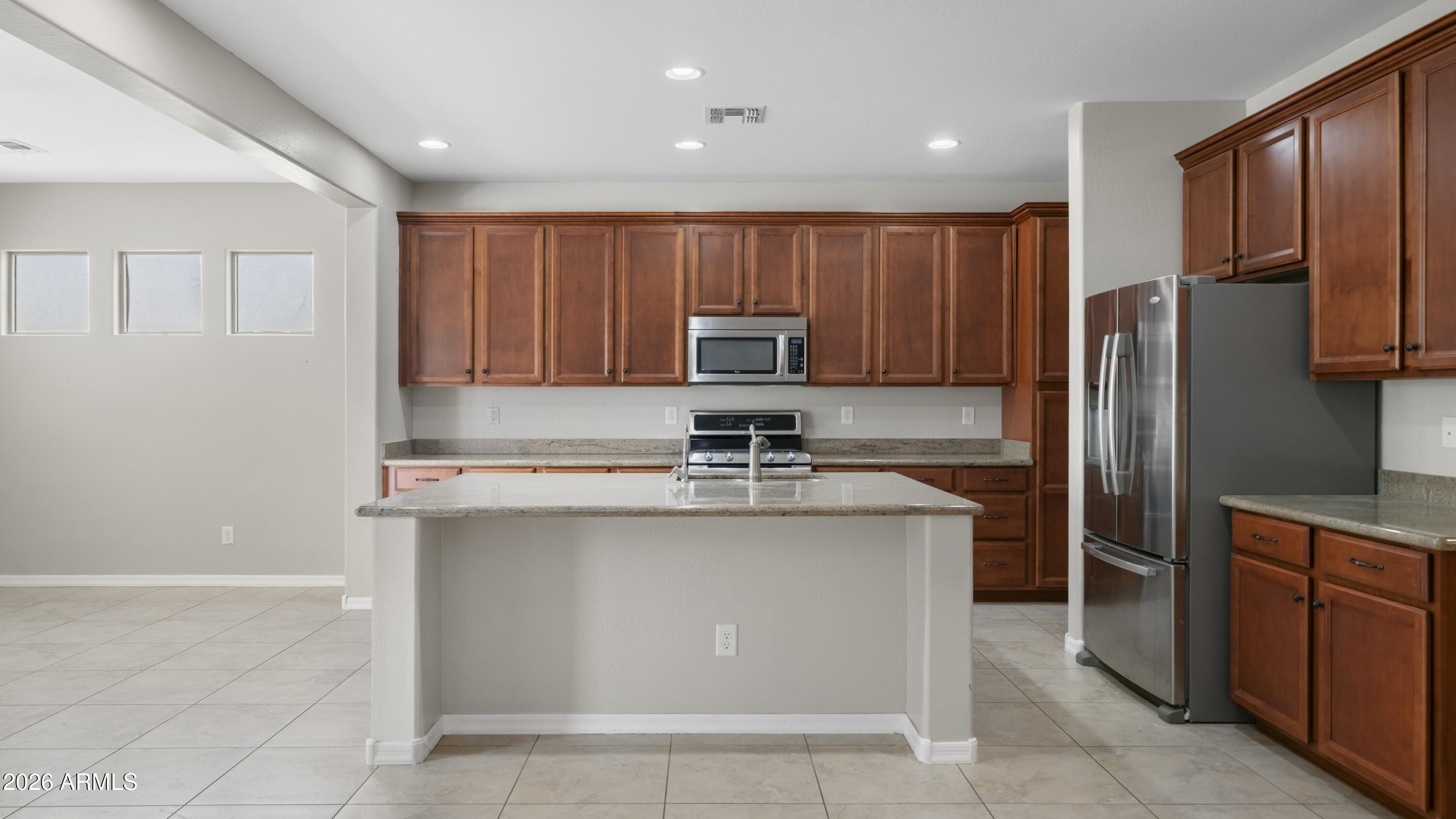 16159 West Granada Road Goodyear, AZ 85395 - Photo 12 of 41 a kitchen with stainless steel appliances granite countertop a sink stove refrigerator and cabinets