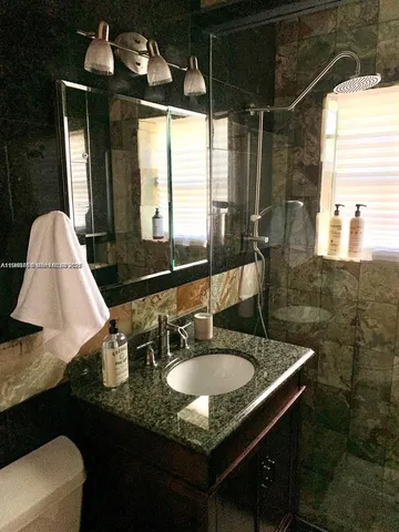 a vase of flowers sitting on a white counter top