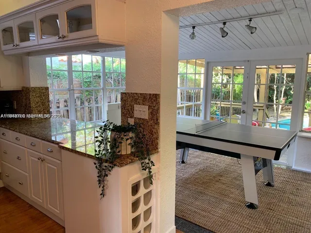 a dining room with furniture and wooden floor