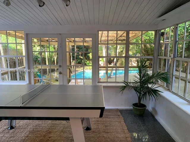 a view of a chairs and table in pool