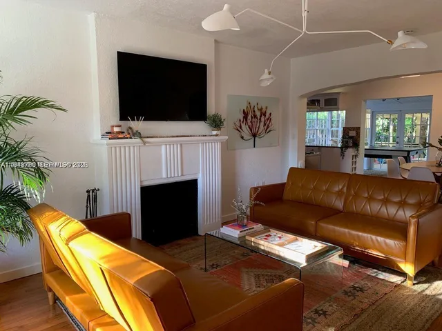 a large bed sitting in a bedroom next to a window