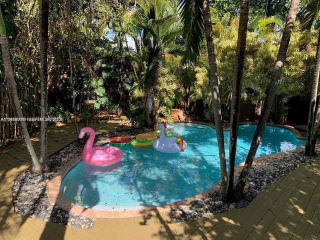 a view of a backyard with plants and a patio