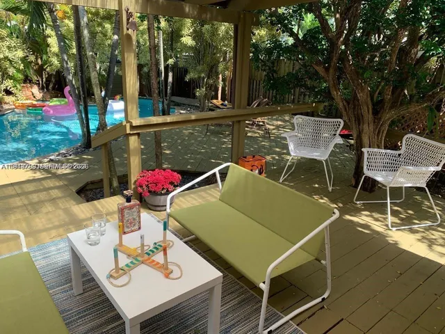 a view of a patio with table and chairs and potted plants