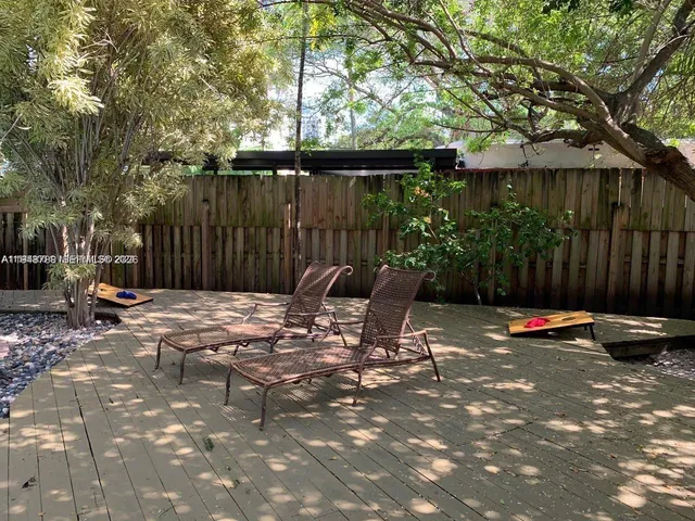 a backyard of a house with barbeque oven table and chairs