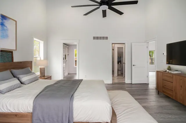 a bedroom with a bed and a flat screen tv