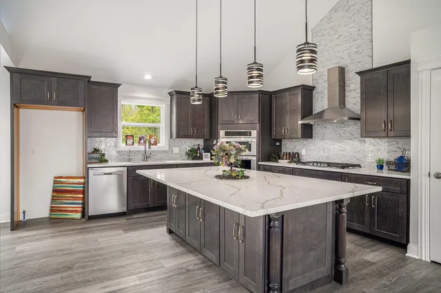 a kitchen with a sink refrigerator and cabinets