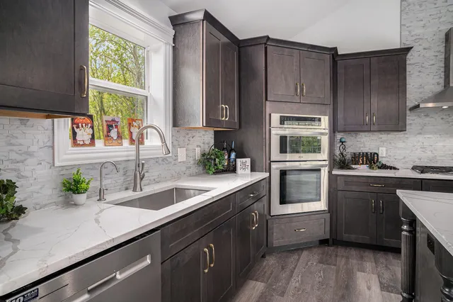 a kitchen with a sink stove and cabinets
