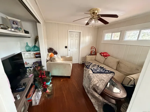 a living room with furniture and a mirror