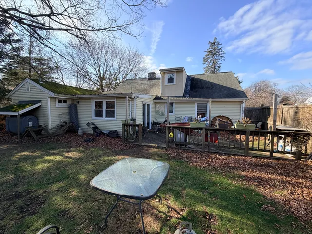 a view of a house with backyard and sitting area