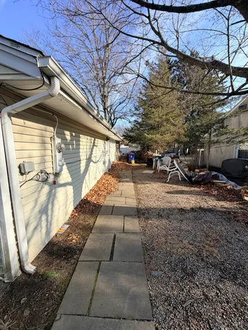 a room with kitchen island stainless steel appliances a sink stove and refrigerator