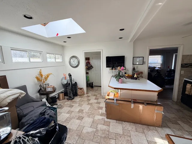 a kitchen with granite countertop a refrigerator and a sink