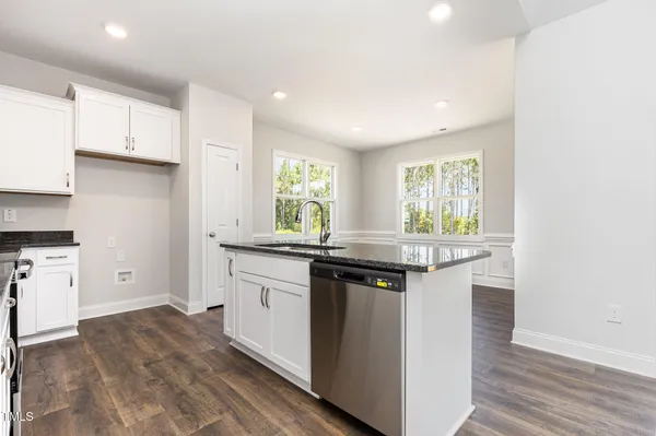 a kitchen with granite countertop a stove and a sink