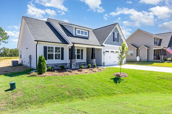 a view of house with swimming pool outdoor seating and yard