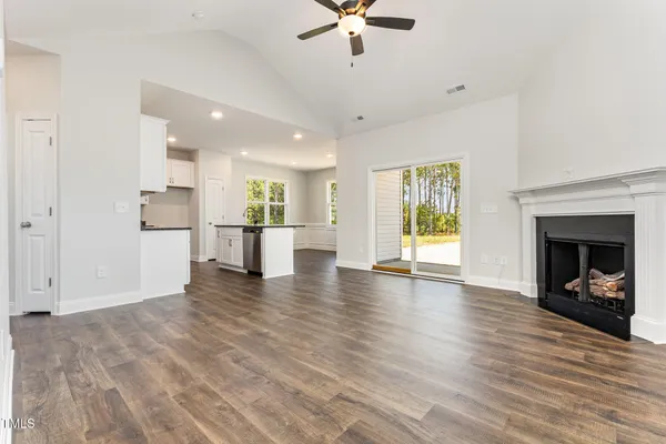 a view of a kitchen with a sink and a fireplace