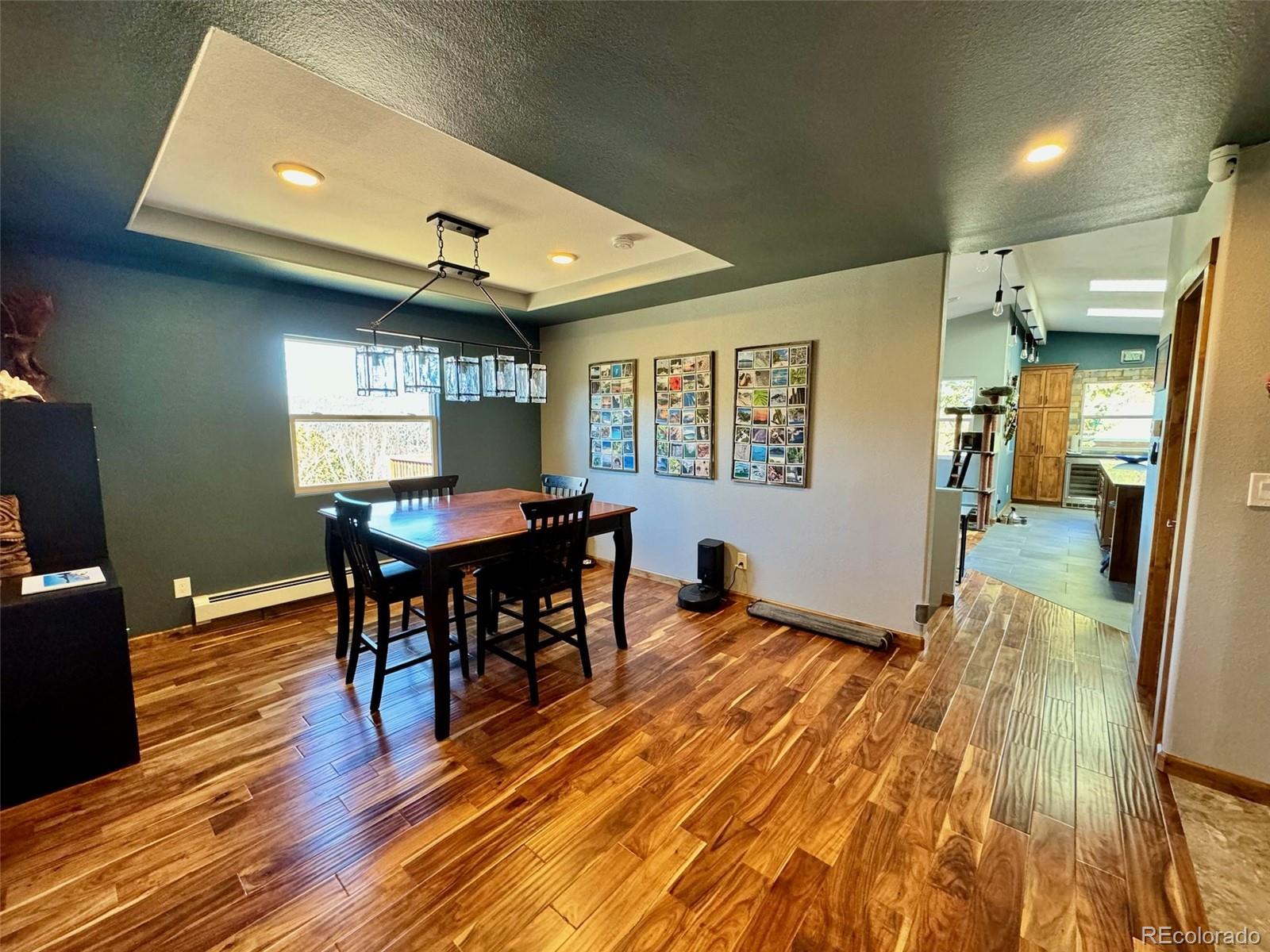 20670 Rangeview Drive Morrison, CO 80465 - Photo 11 of 39 a view of a dining room with furniture and wooden floor