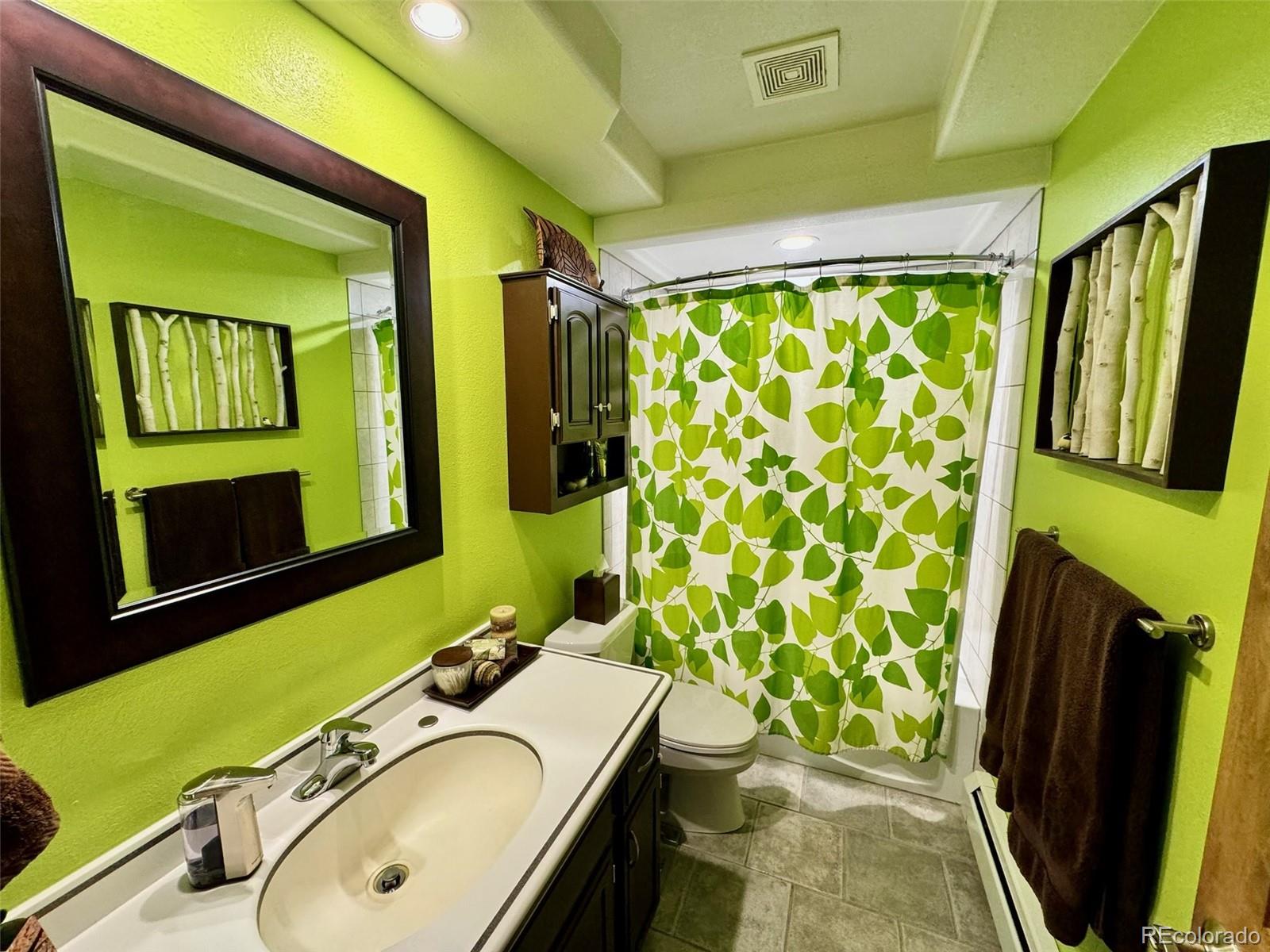 20670 Rangeview Drive Morrison, CO 80465 - Photo 12 of 39 a bathroom with a sink toilet and a mirror