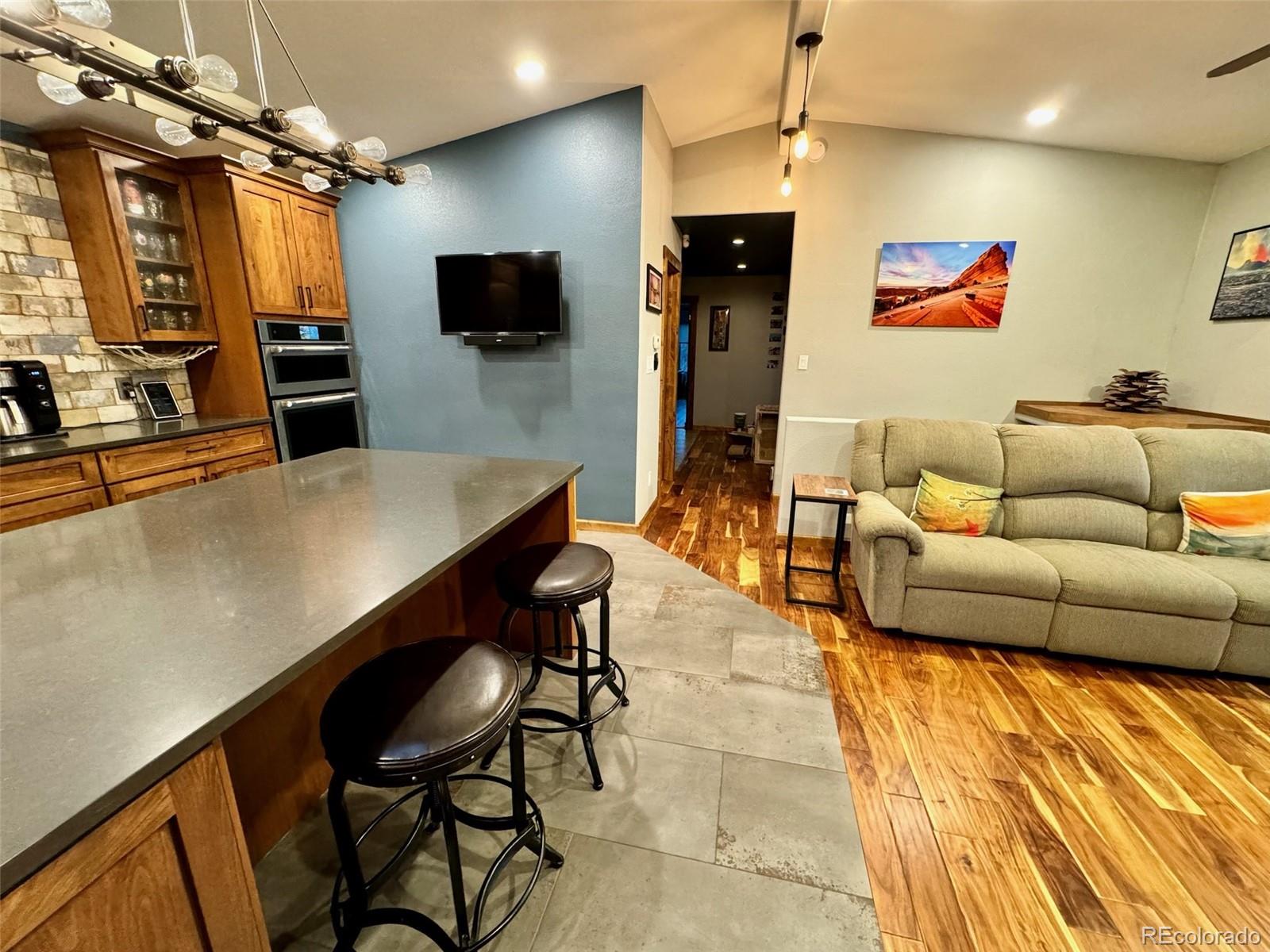 20670 Rangeview Drive Morrison, CO 80465 - Photo 14 of 39 a living room with furniture and a flat screen tv