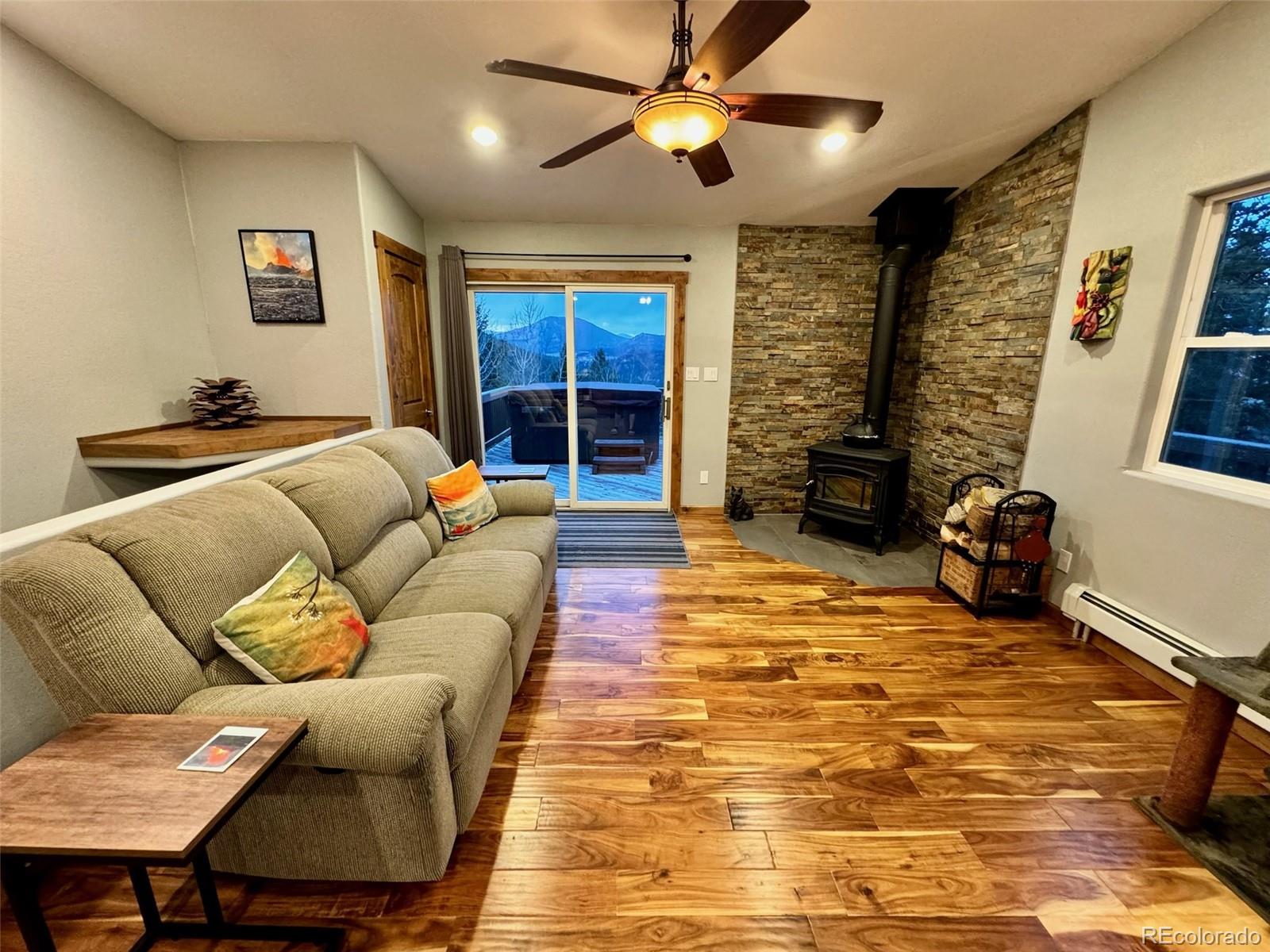 20670 Rangeview Drive Morrison, CO 80465 - Photo 16 of 39 a living room with furniture ceiling fan and a rug